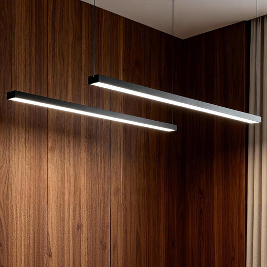 Commercial linear pendant lighting mounted near a wood accent wall.