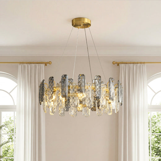 Stunning ring-shaped contemporary crystal chandeliers featuring a gold frame with alternating clear and smoky textured crystal pendants in an elegant room.