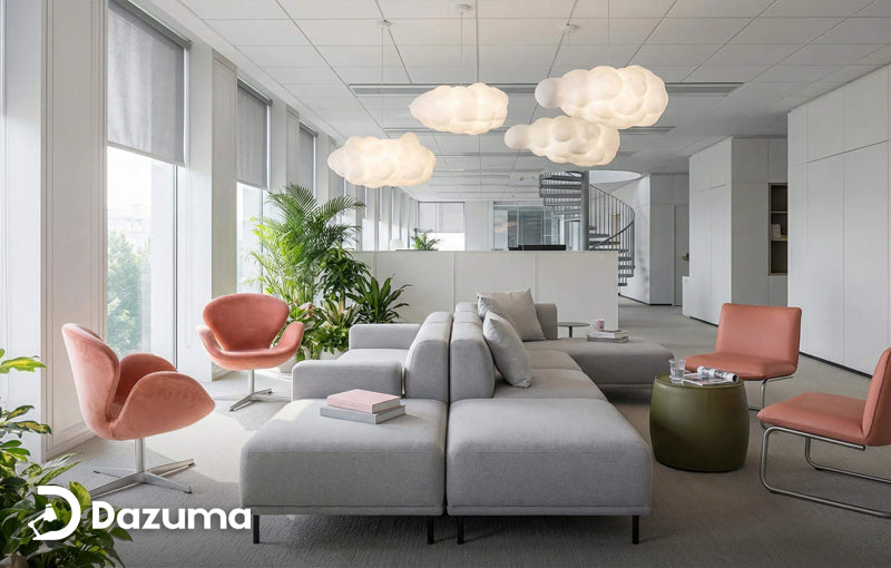Modern open office workspace at Astera Cloud Systems featuring linear ceiling lighting and contemporary lounge seating.