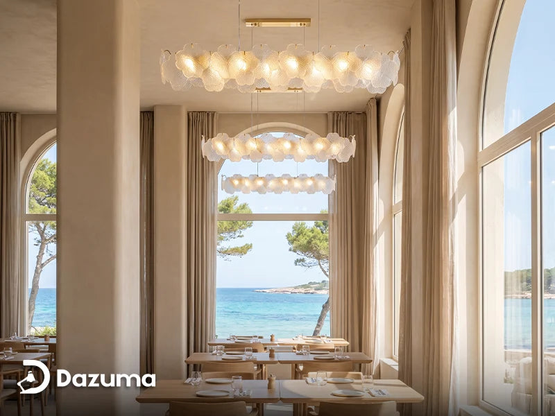airy coastal dining room with a clear glass chandelier