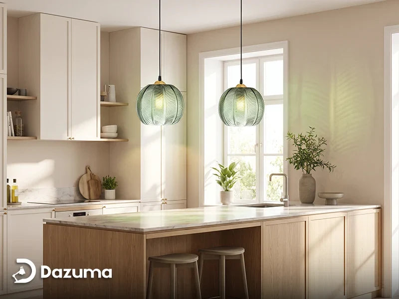 green pendant lights above warm white cabinets and a light oak kitchen island