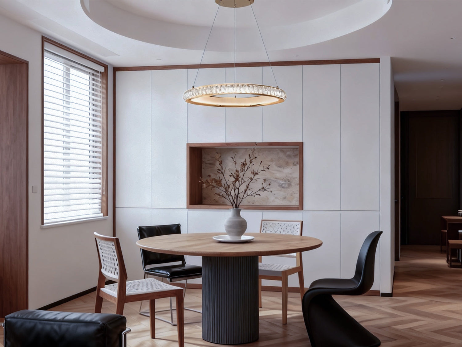 Minimalist dining room featuring a slim linear pendant light above a round dining table with warm ambient lighting.