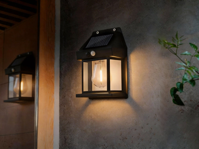 Outdoor solar wall light installed on exterior wall at night.