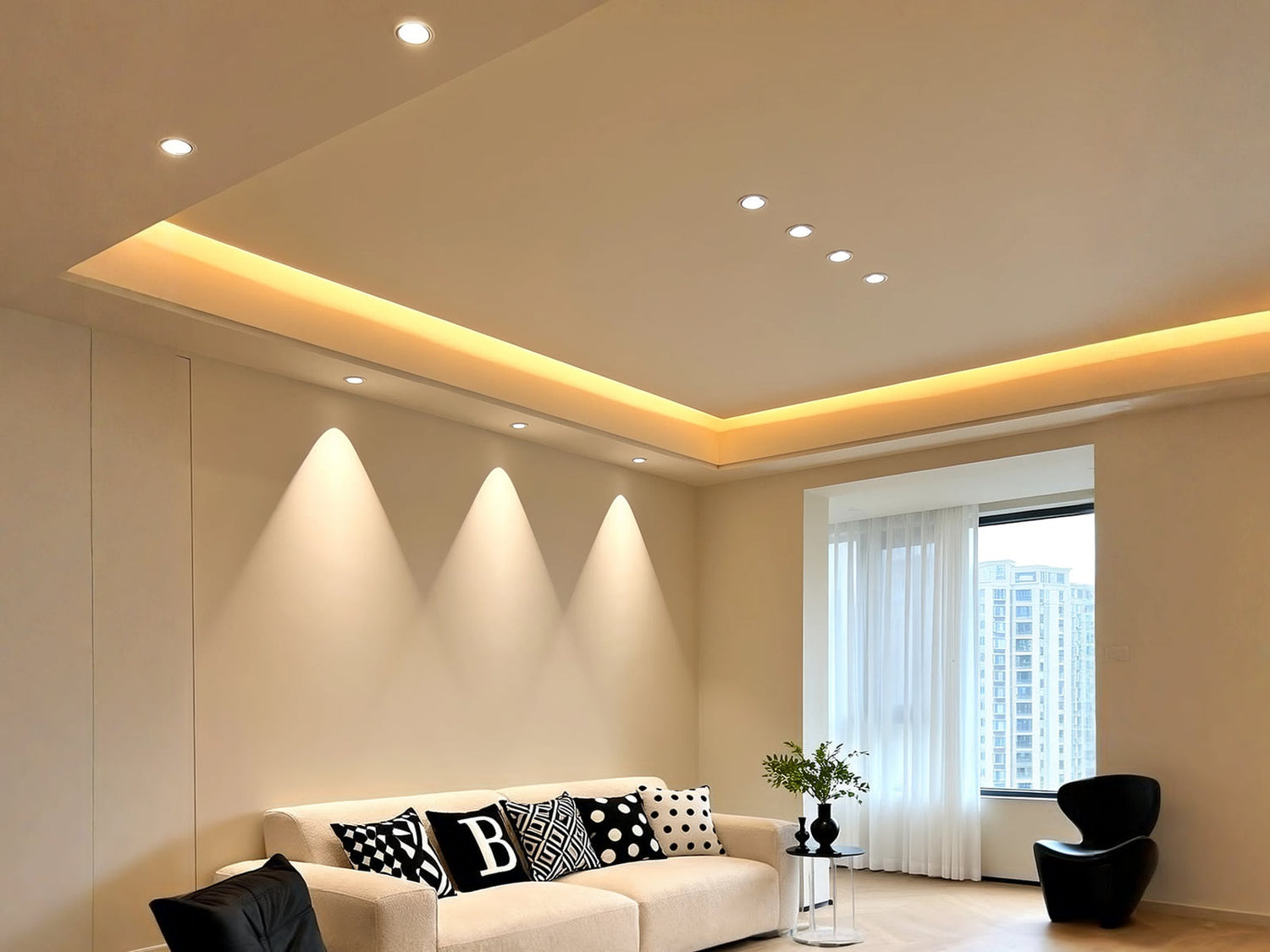 Modern living room with recessed ceiling lights and warm LED strip accent.