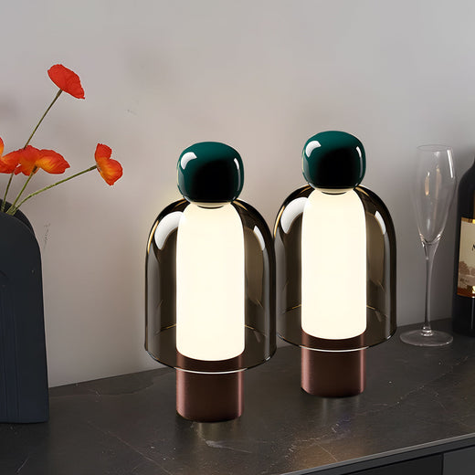 Portable glass table light with a close-up of the transparent glass and wooden base.