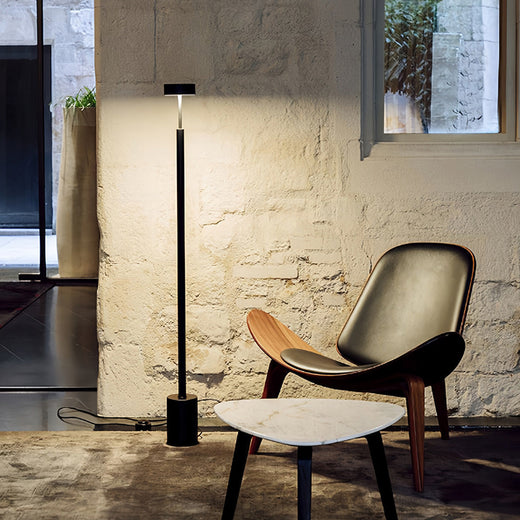 Industrial-style LED petite floor lamp in loft setting showcasing versatile lighting for creative workspace environments