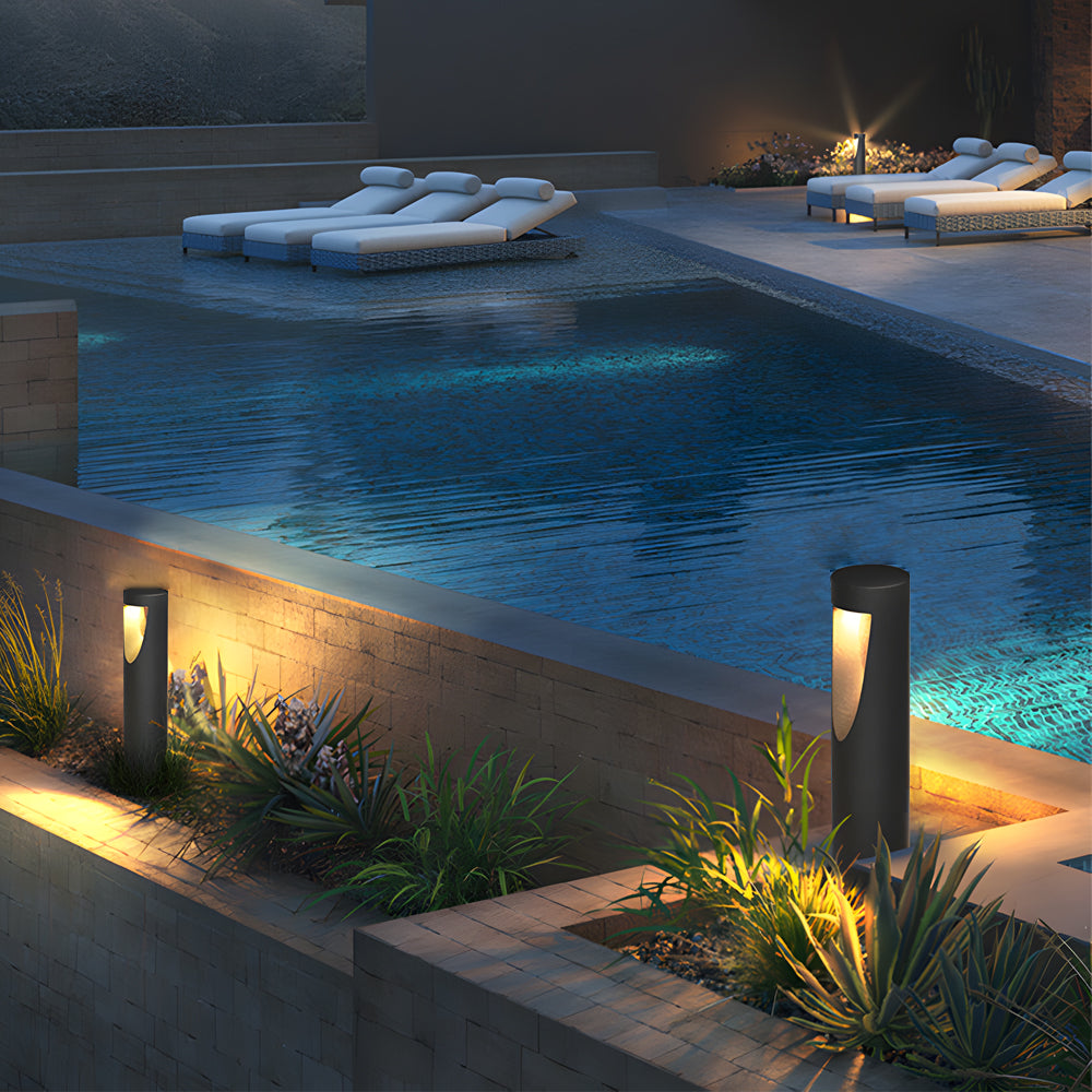 Poolside area enhanced with contemporary bollard lights creating ambient evening atmosphere