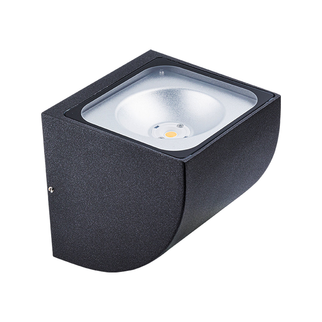 Traditional brass wall lantern with frosted glass shade mounted on stone exterior wall