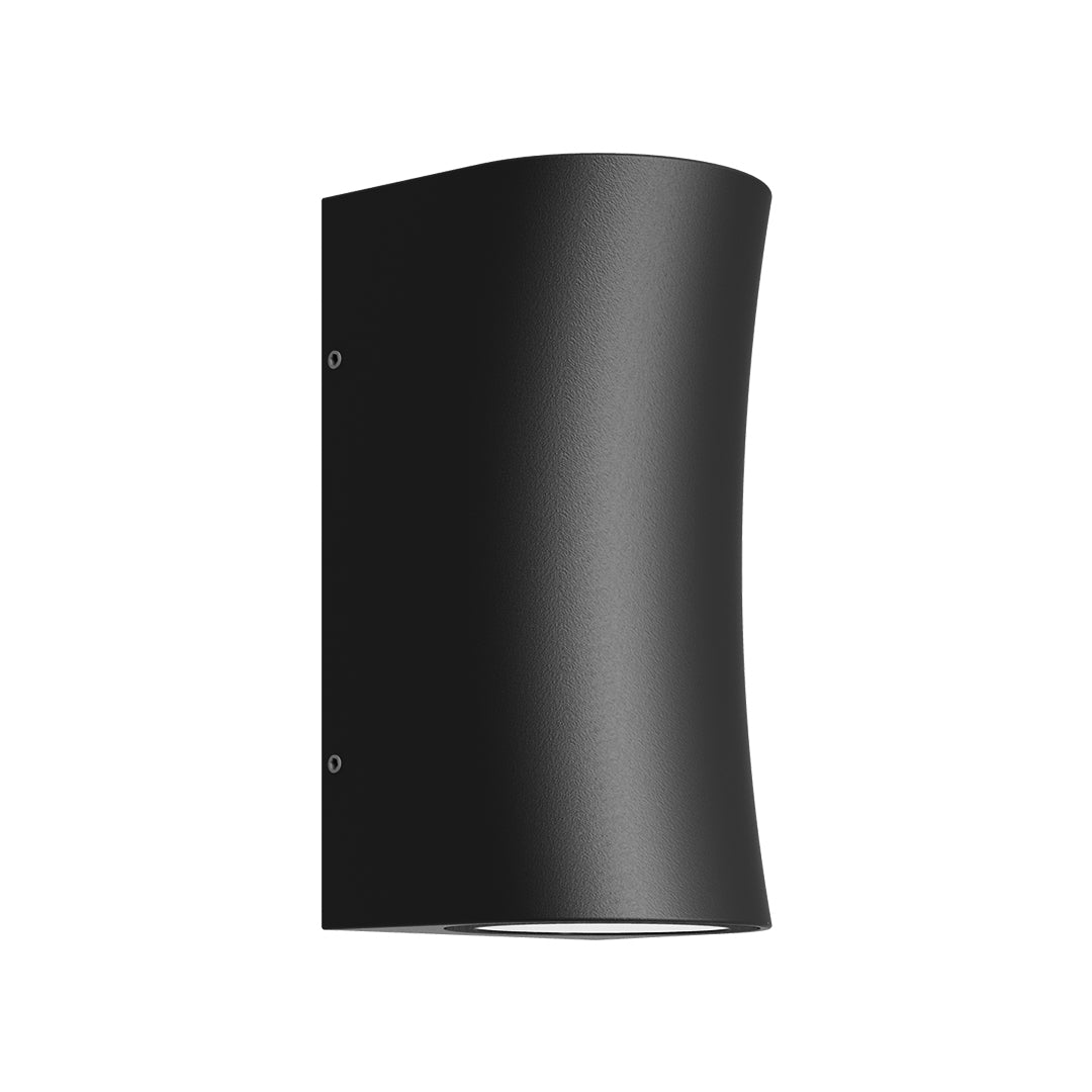 Modern black wall sconce casting dramatic directional lighting against textured architectural surface