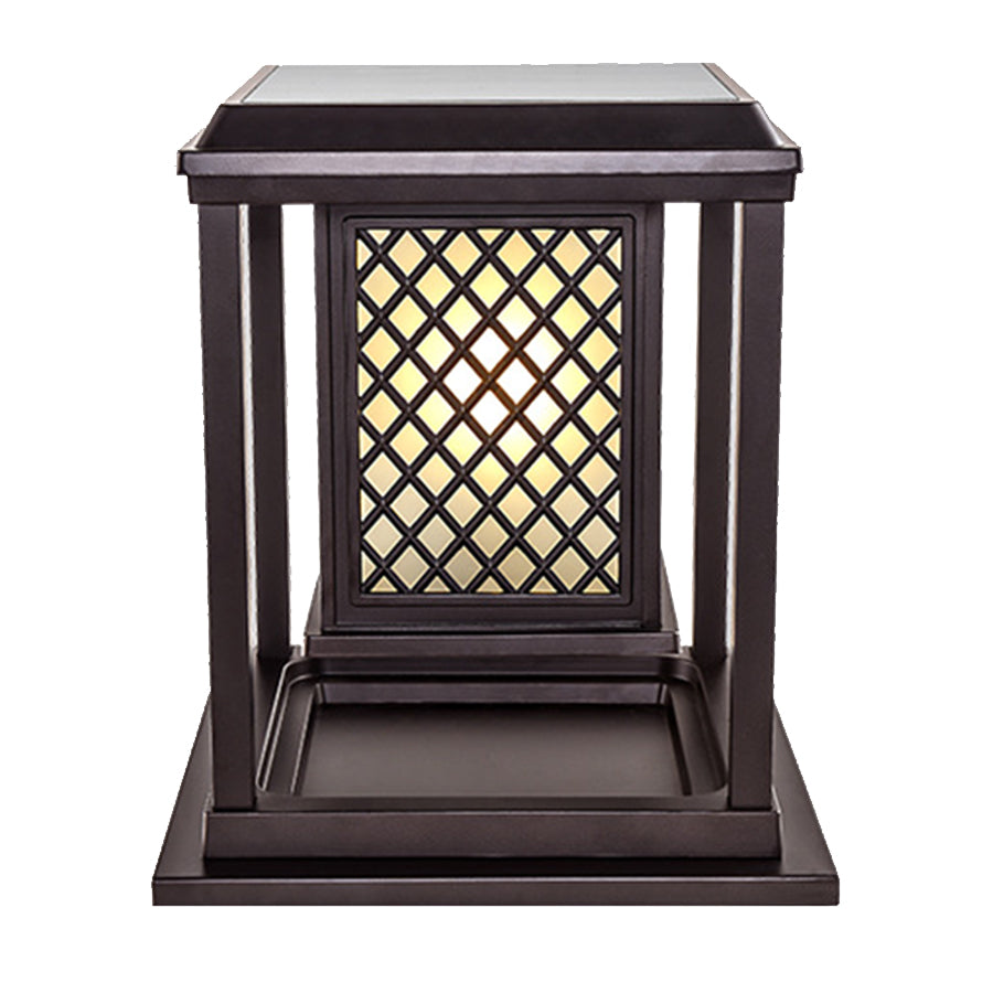 Two elegant post cap lights with vertical bar design illuminating concrete pillars at evening