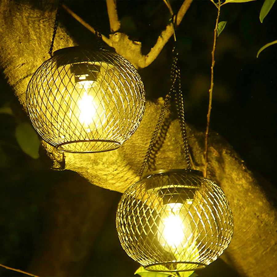 Warm golden light emanating from woven hanging lantern creating magical outdoor ambiance