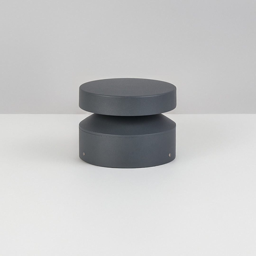 Studio view of a single 110v landscape light, showing its compact cylindrical design and clean matte finish.