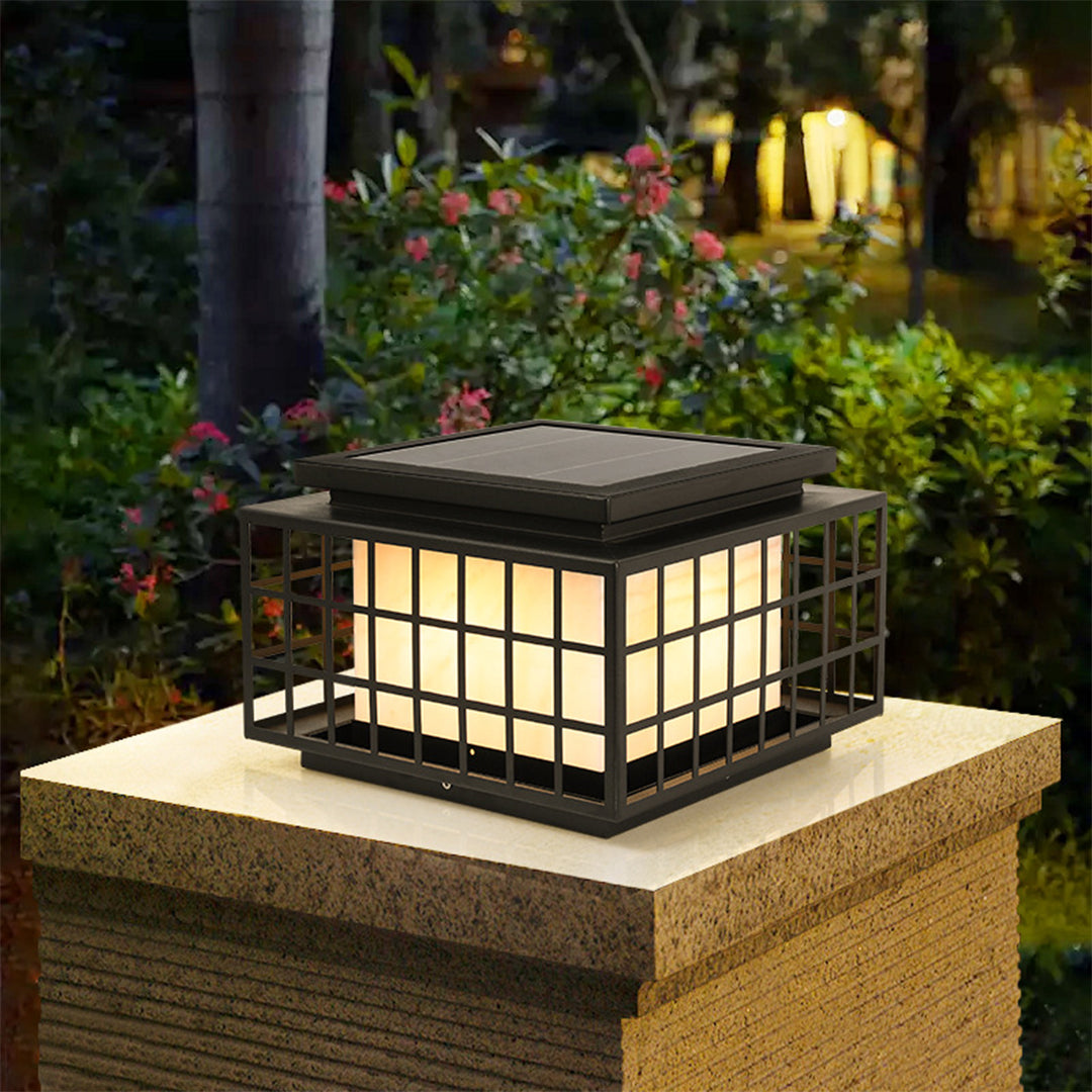 Japanese-style solar lanterns placed on stone surface creating peaceful zen garden atmosphere with natural rock elements