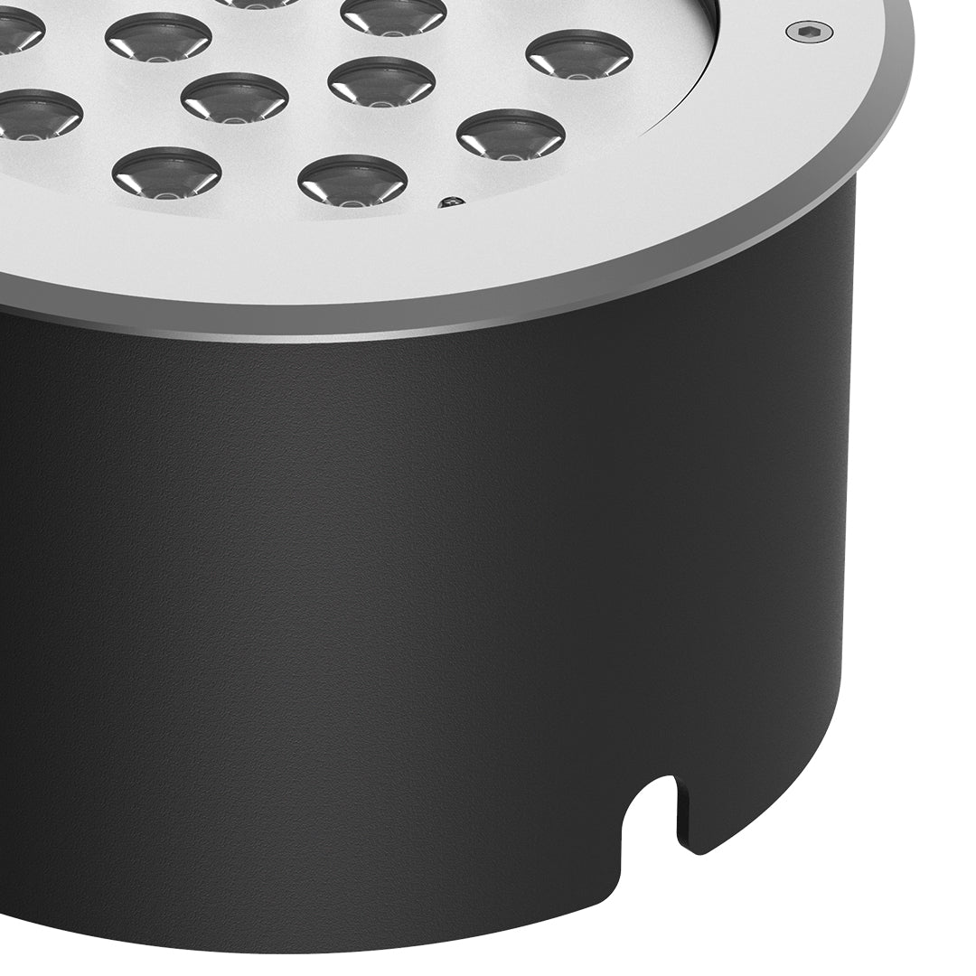 Black cylindrical ground light housing with cutout design for recessed landscape lighting installation