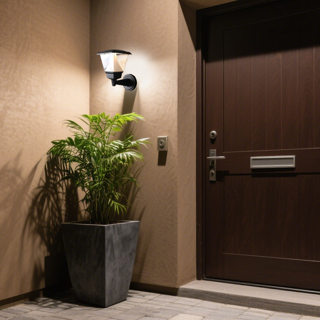 Elegant residential entrance featuring warm outdoor lighting and Mediterranean-style architectural details