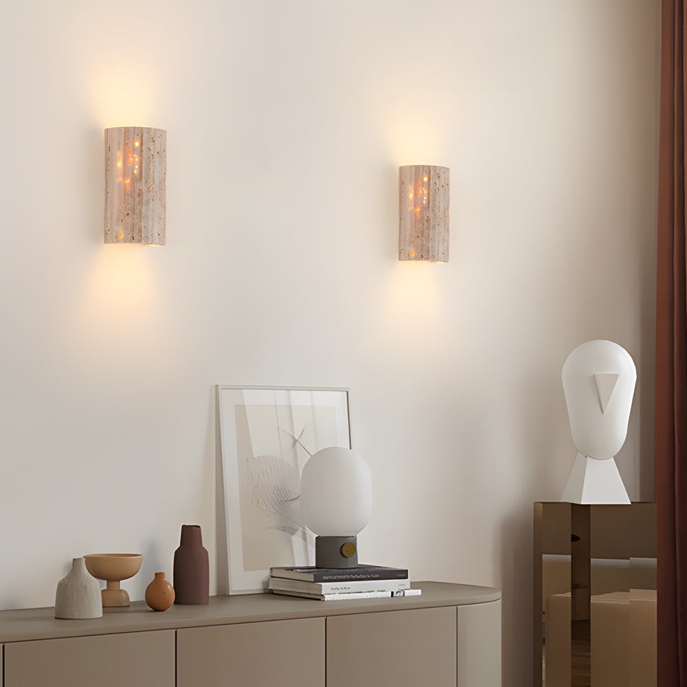 Minimalist living area showcasing paired travertine wall fixtures with clean geometric design