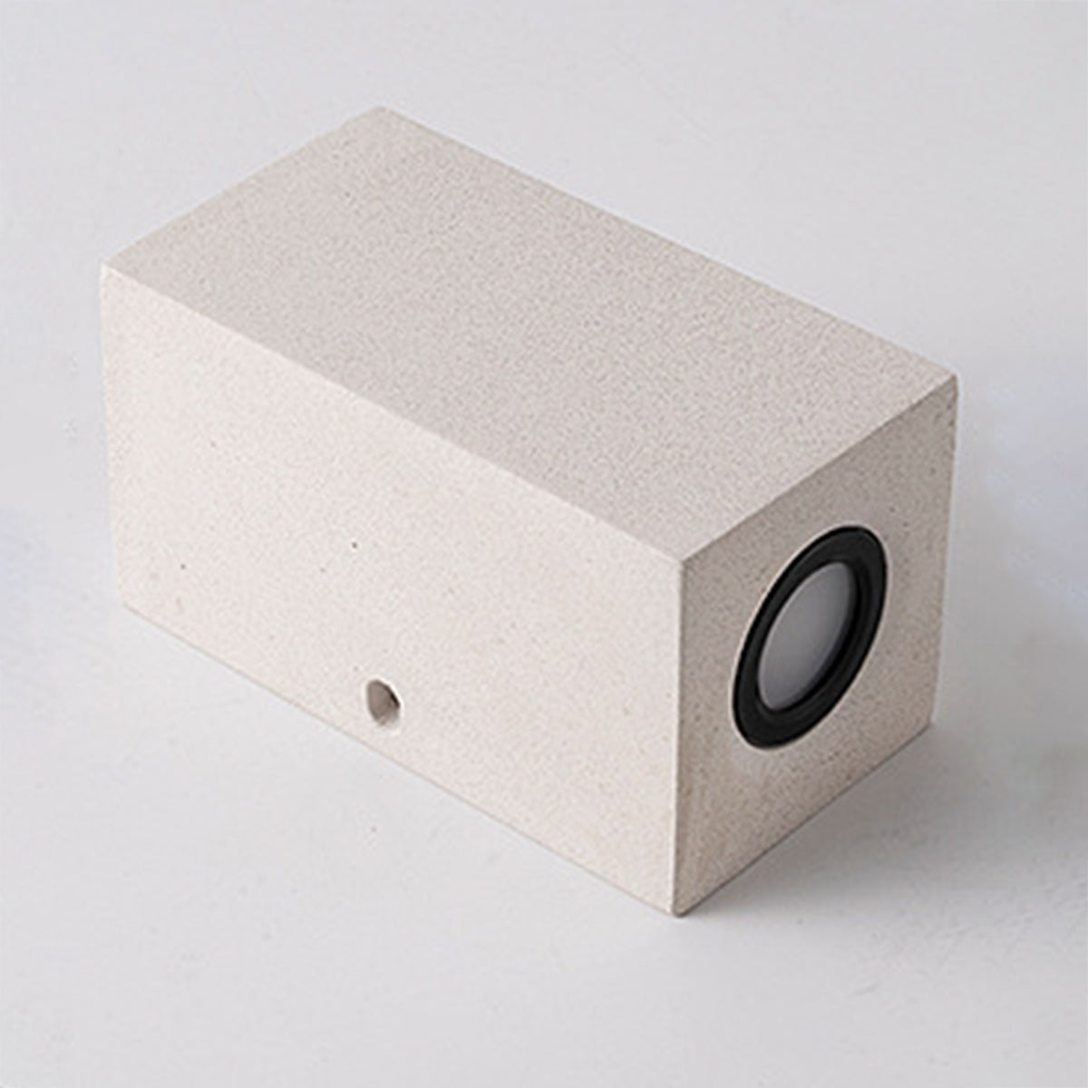 Modern cubic concrete light fixture with circular LED aperture for architectural accent lighting