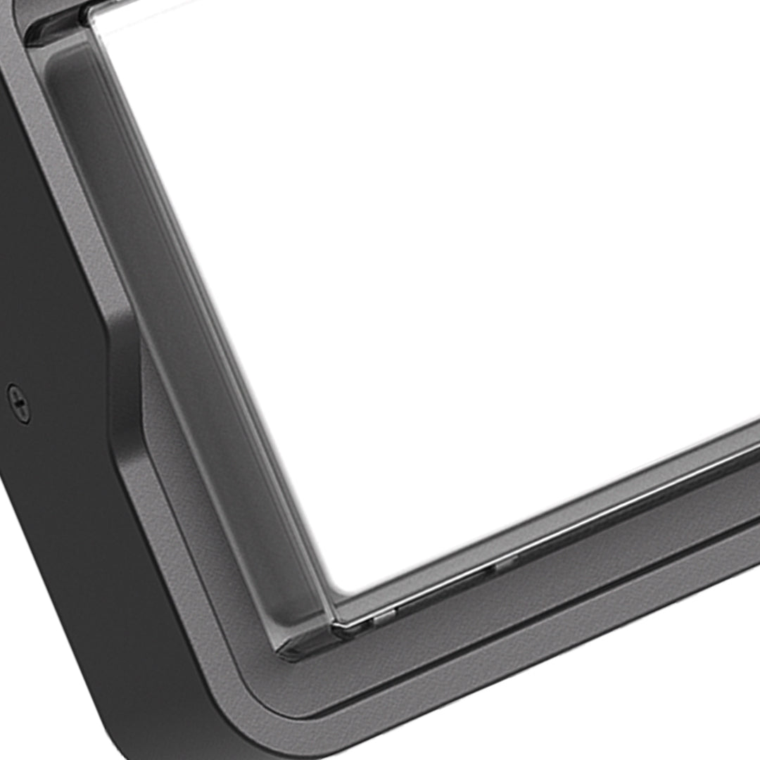 Outdoor wall light with angled black housing and directional beam capabilities