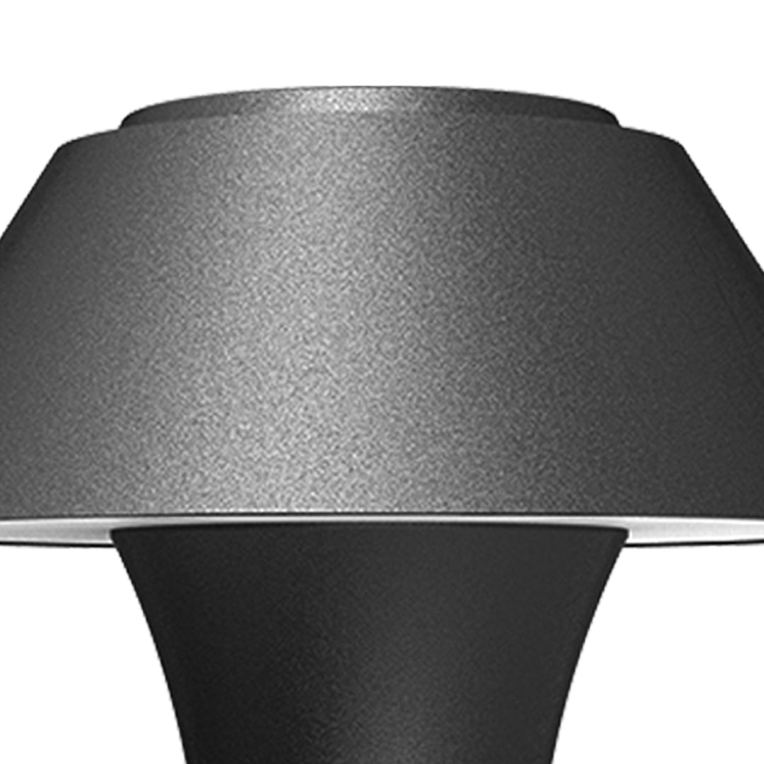 Modern black dome wall light with extending arm illuminating brick exterior wall at dusk