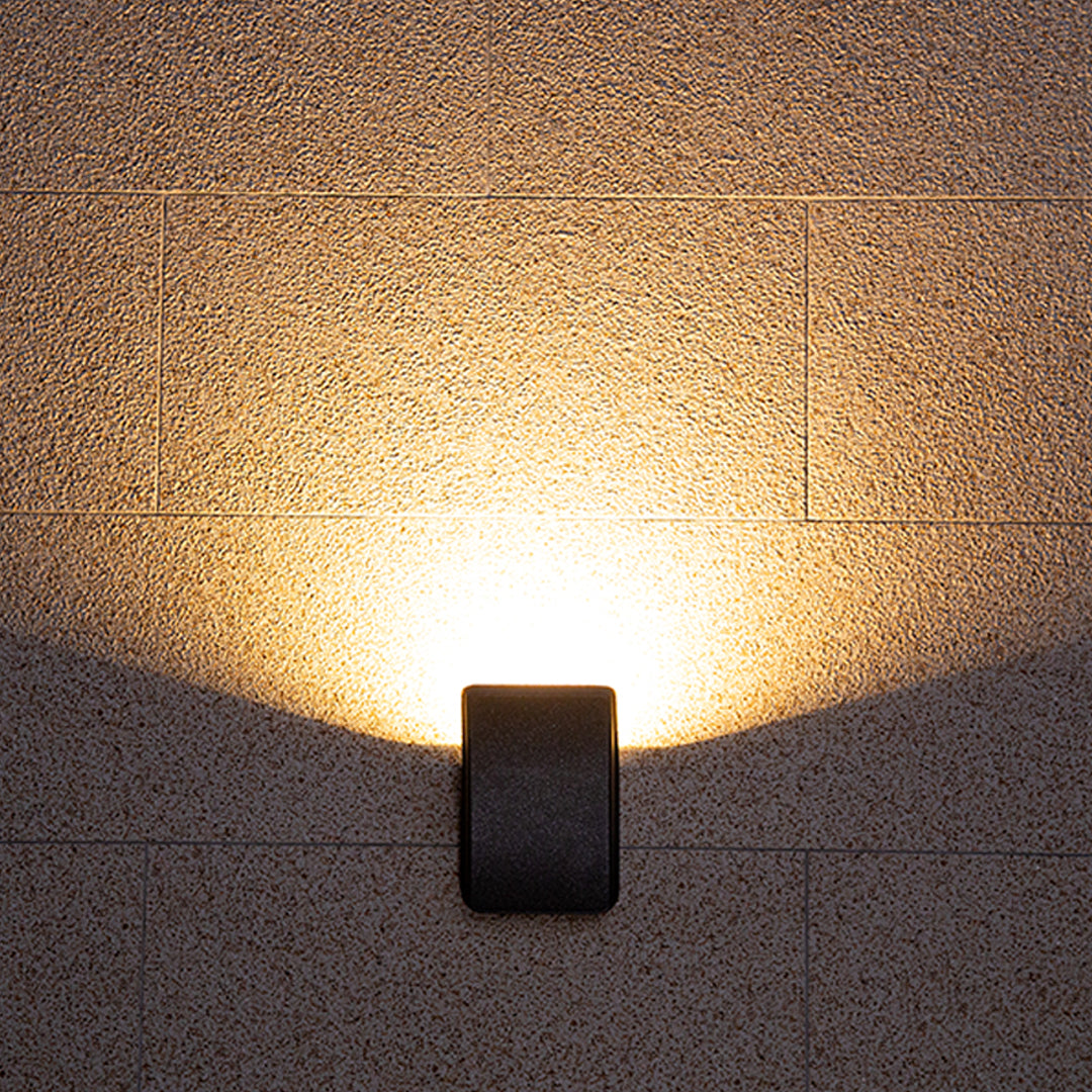 Curved charcoal wall light with organic flowing design and sophisticated modern appeal