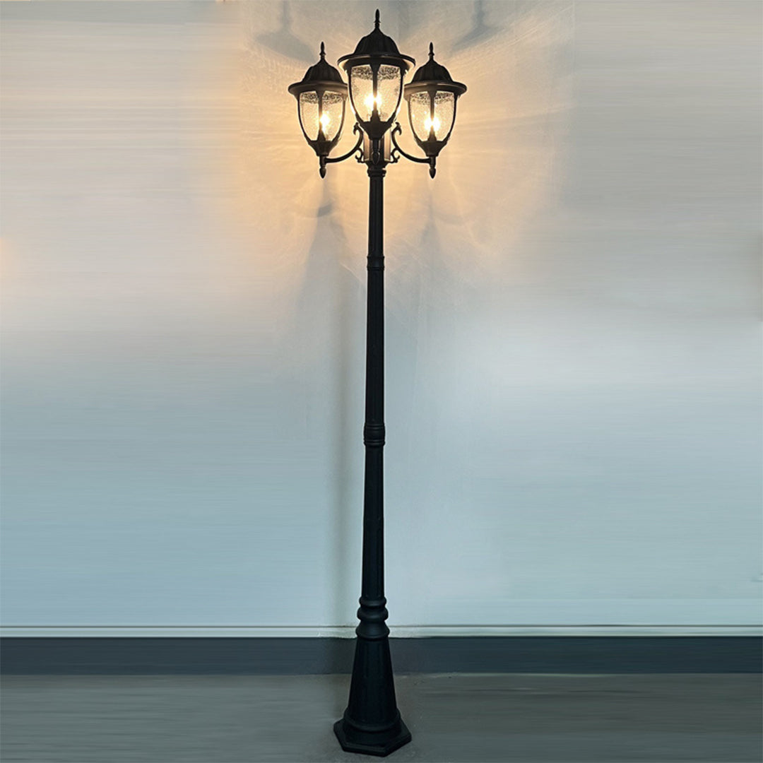 Street lamp illuminated at dusk against cloudy sky creating atmospheric evening lighting