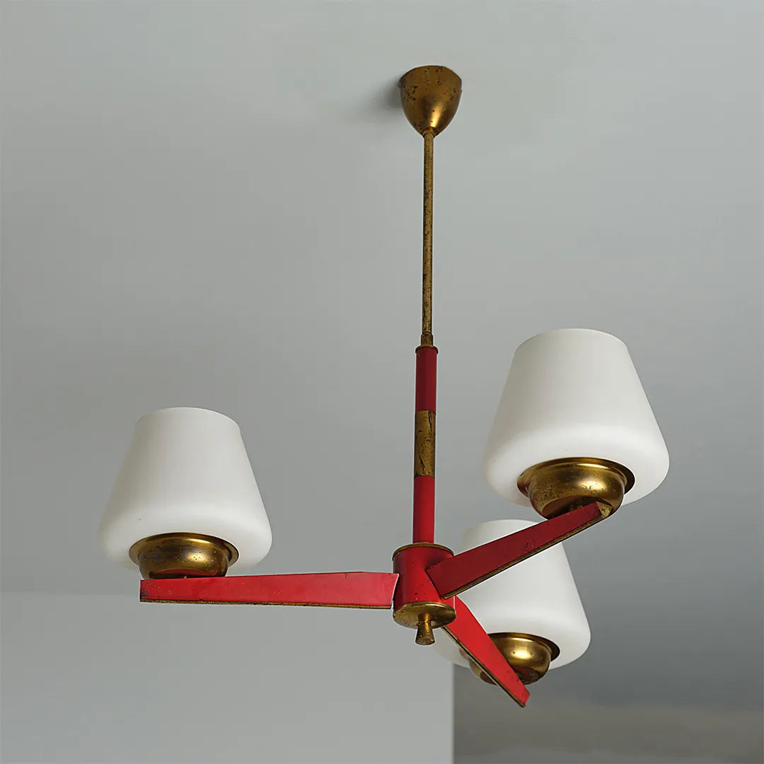 3 light chandeliers product image showing three white lampshades with a red and brass metal frame.