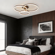 3-ring flush mount illuminating a modern bedroom with warm, ambient glow.