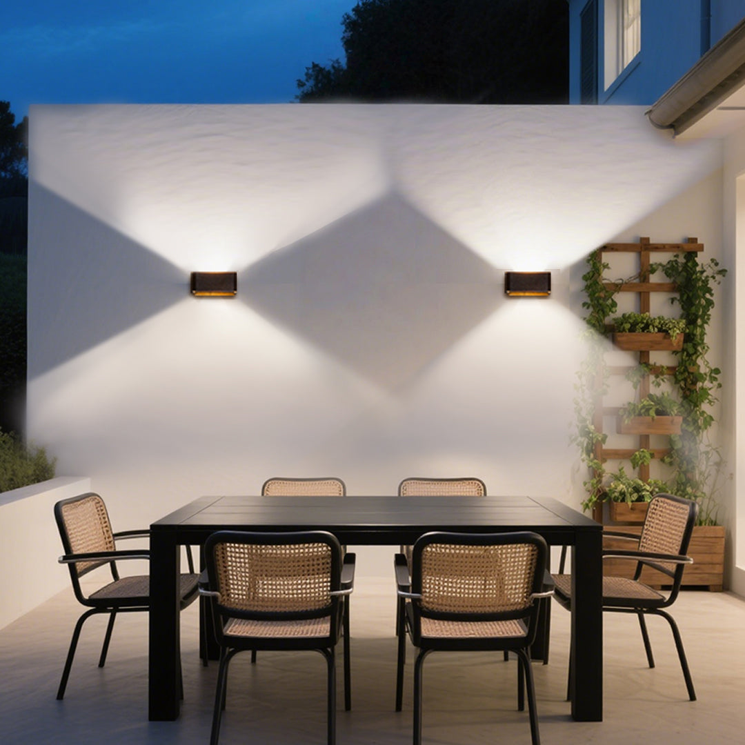 Contemporary wall-mounted LED fixture with angular black housing and directional beam