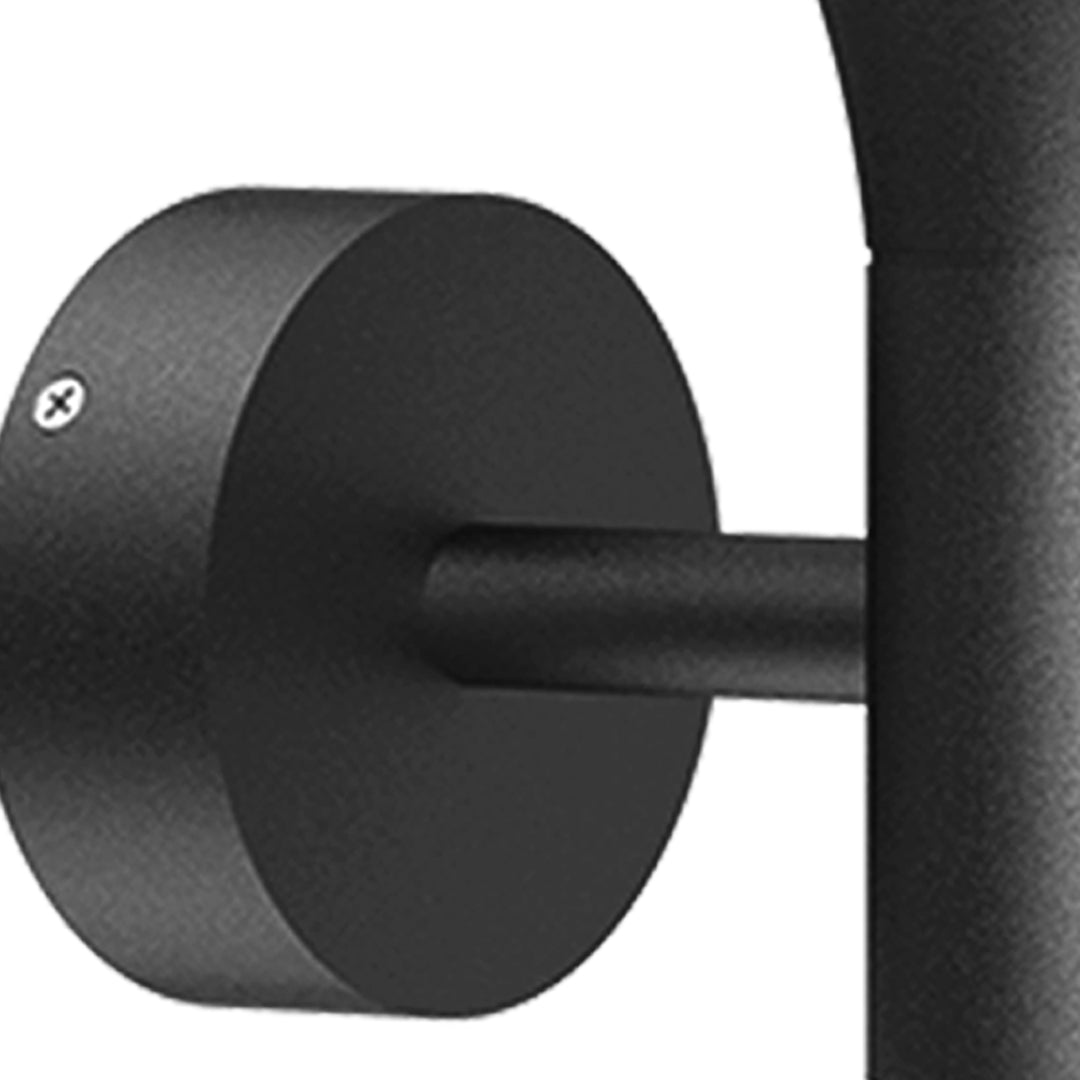 Modern black dome wall light with extending arm illuminating brick exterior wall at dusk