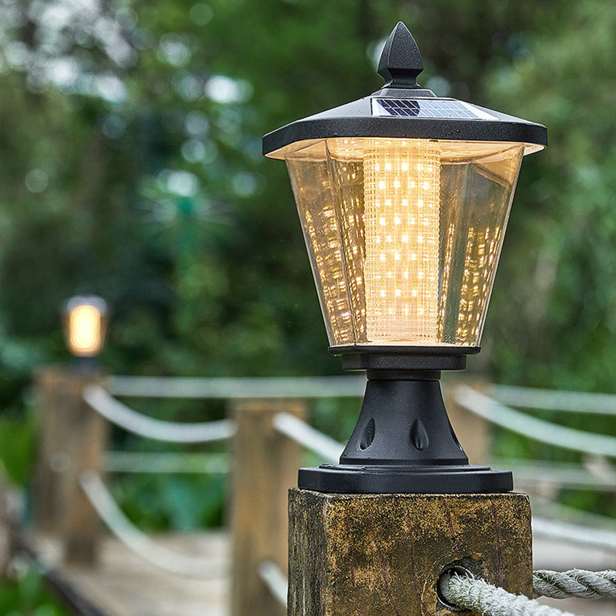 Illuminated post top lantern with warm LED light creating cozy evening atmosphere