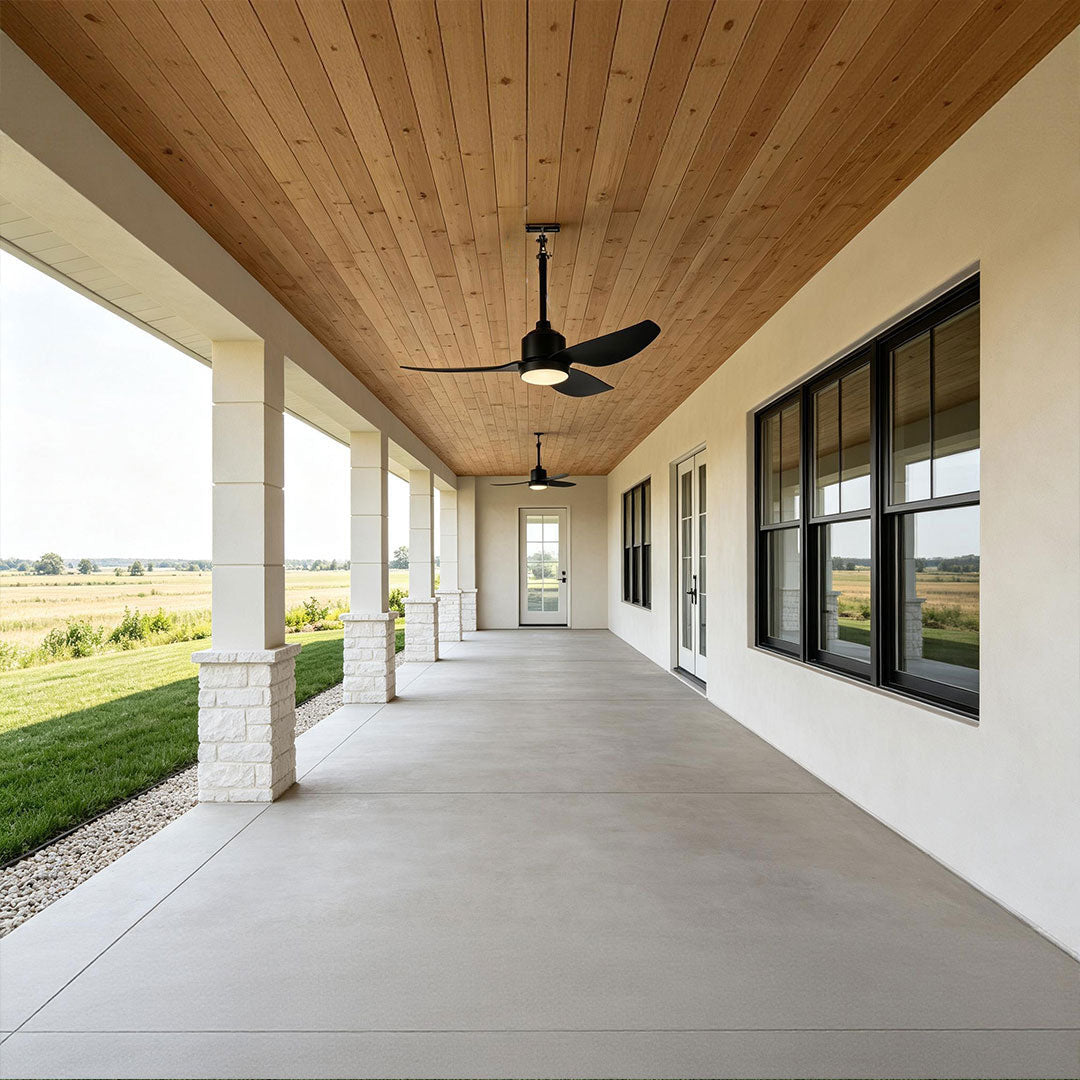 42 inch black ceiling fan with light installed along a spacious covered farmhouse porch.