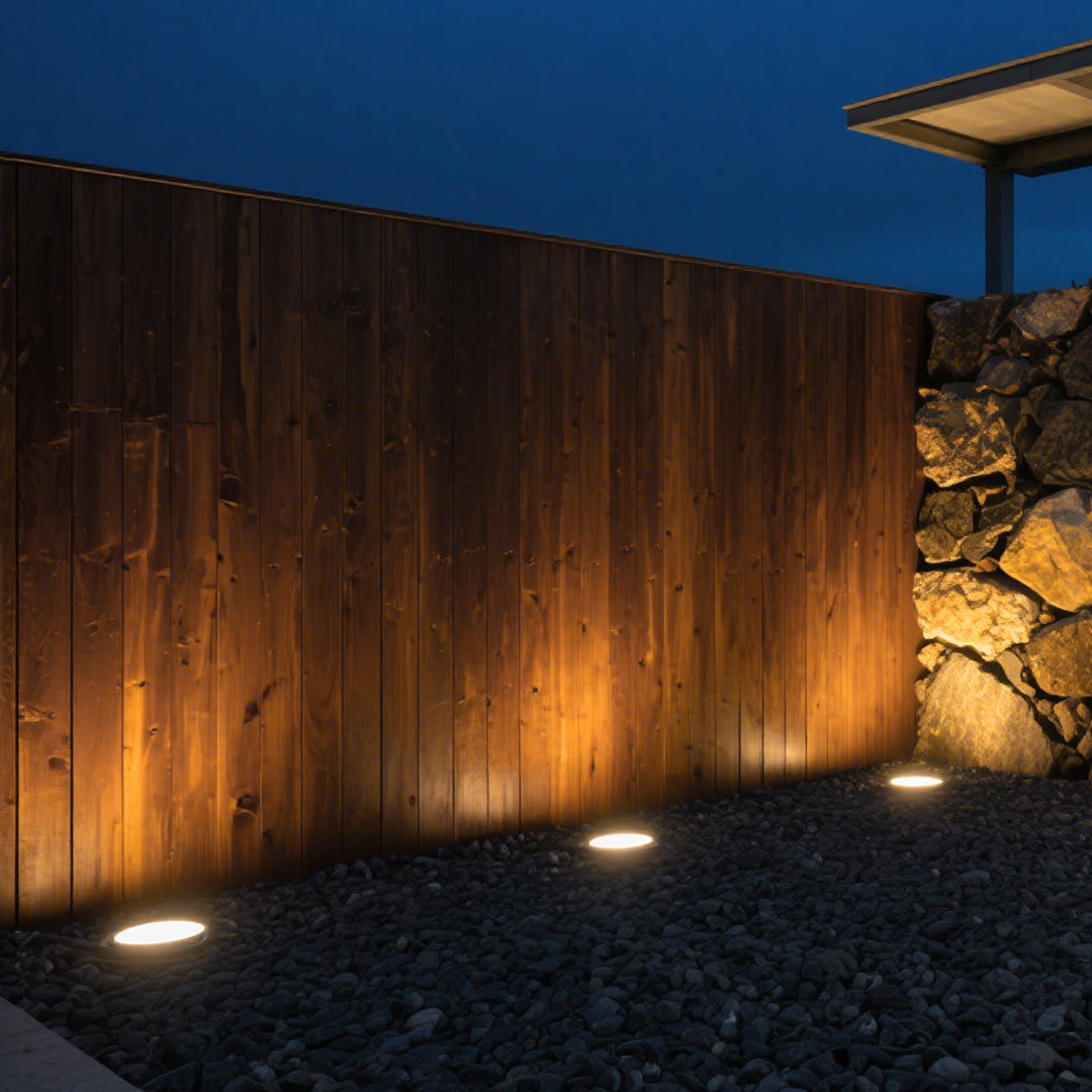 Modern in-ground light fixture with prismatic lens and metal housing for landscape accent lighting