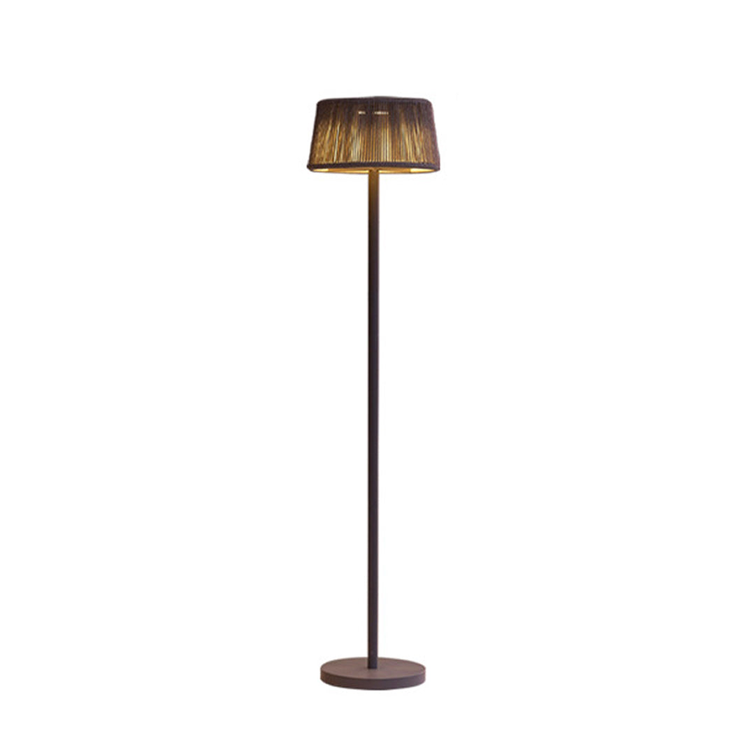Elegant solar floor lamp with woven rattan shade and dark metal pole against white background