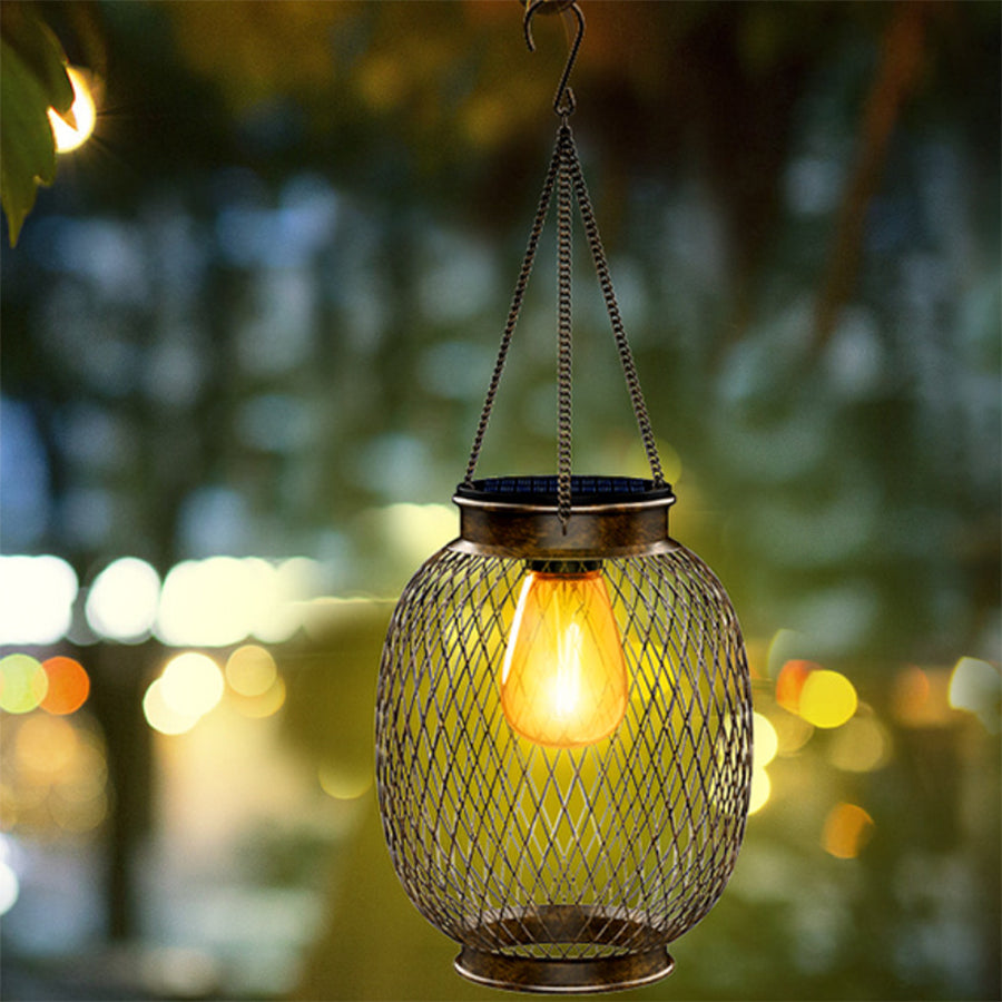 Solar hanging lantern illuminated among tree branches creating natural outdoor lighting effect