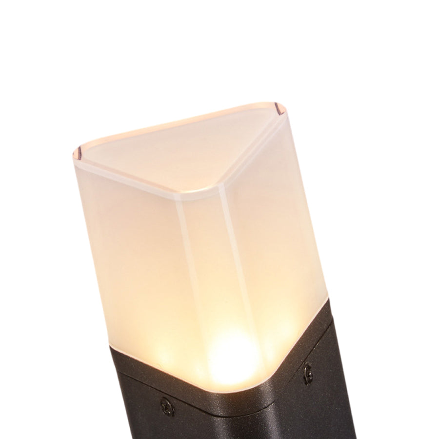 Tall solar pathway light with clean geometric design positioned along stone garden border