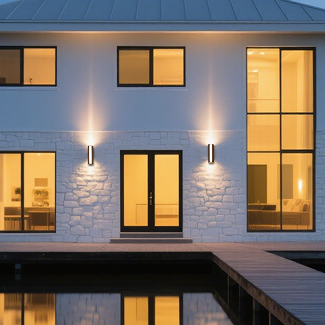 Outdoor wall light casting warm golden glow on brick surface with dramatic shadow effects