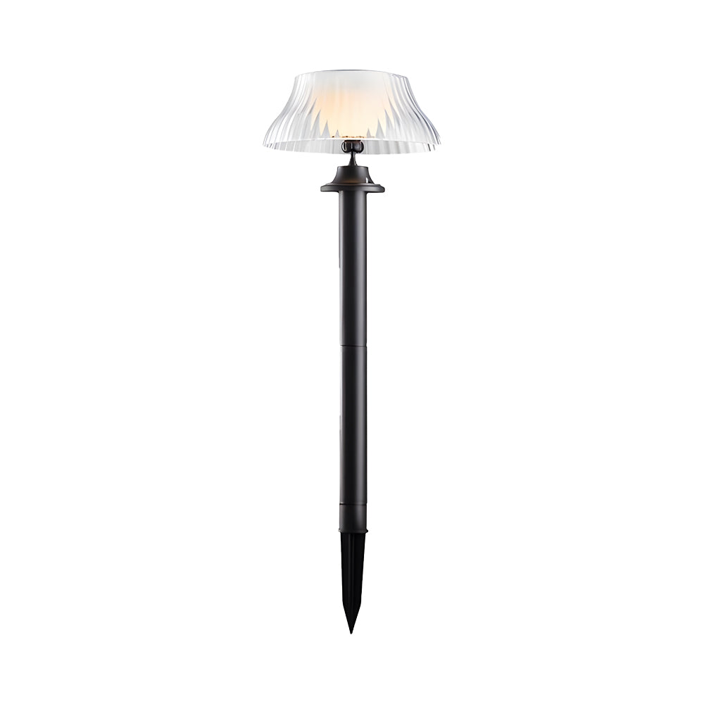 Single solar pathway light with ribbed glass shade and black metal stake for garden installation