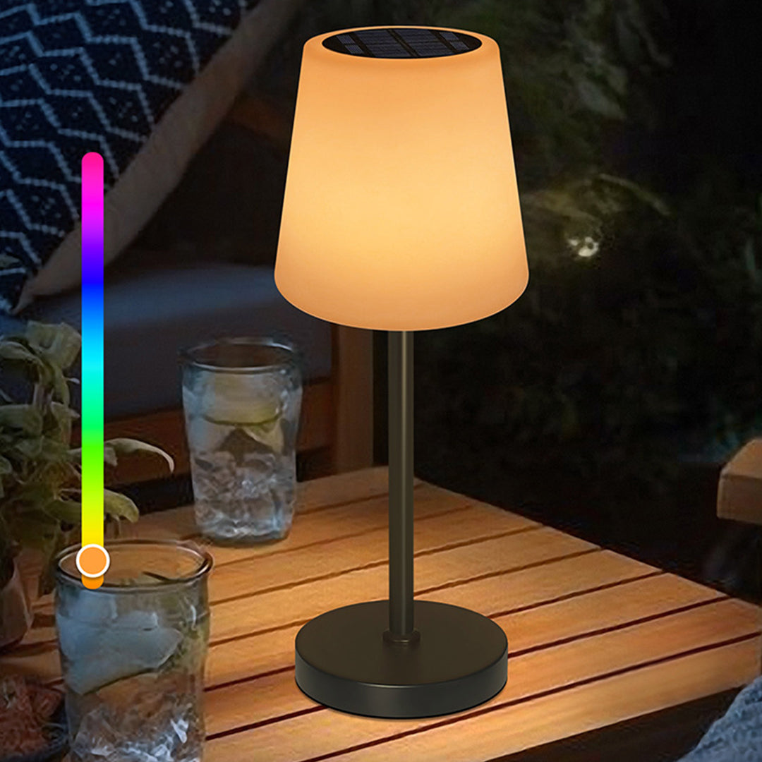 Portable LED lamp illuminating outdoor dining setup on wooden table with evening ambiance