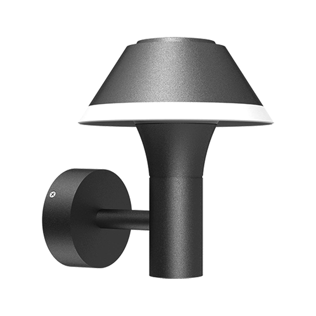 Contemporary outdoor wall sconce with conical shade casting warm light on white siding