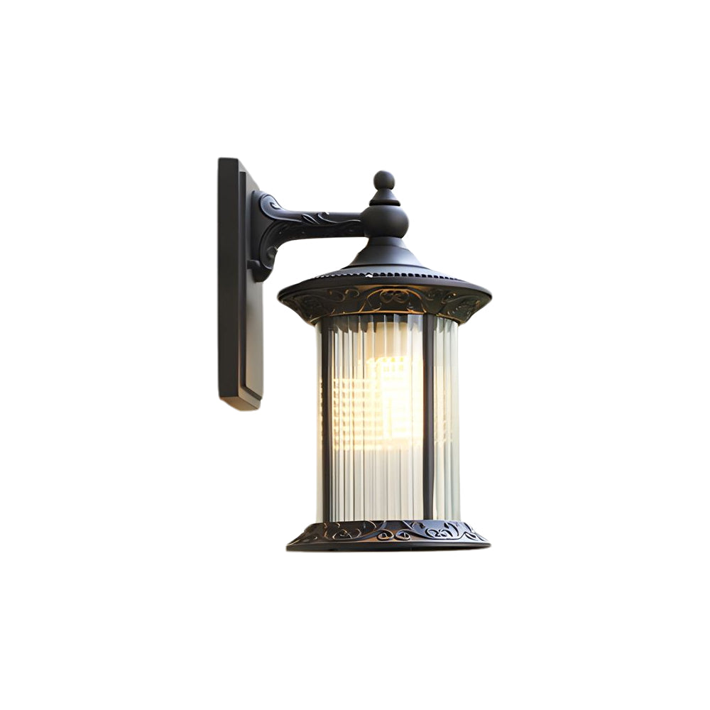 Traditional black outdoor wall lantern with ribbed glass shade and decorative mounting bracket in classic colonial style