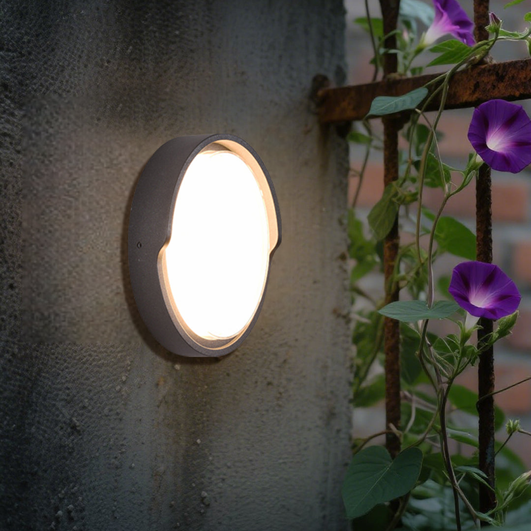Modern black circular wall light with white LED panel for contemporary interior applications