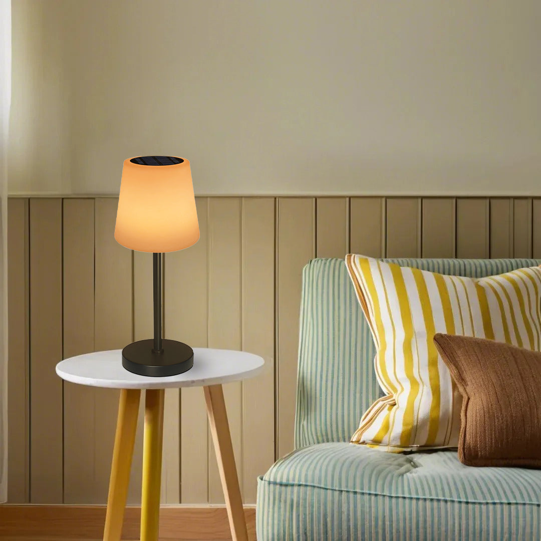 Modern portable lamp creating cozy lighting atmosphere on side table next to comfortable reading chair