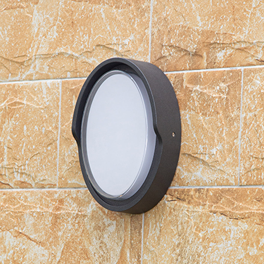 Modern black circular wall light with white LED panel for contemporary interior applications