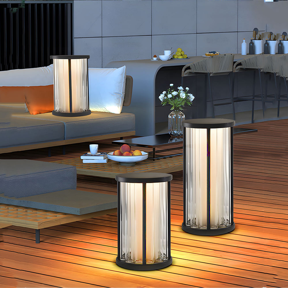 Modern patio setting with portable cylindrical floor lamps providing elegant ambient lighting for evening relaxation