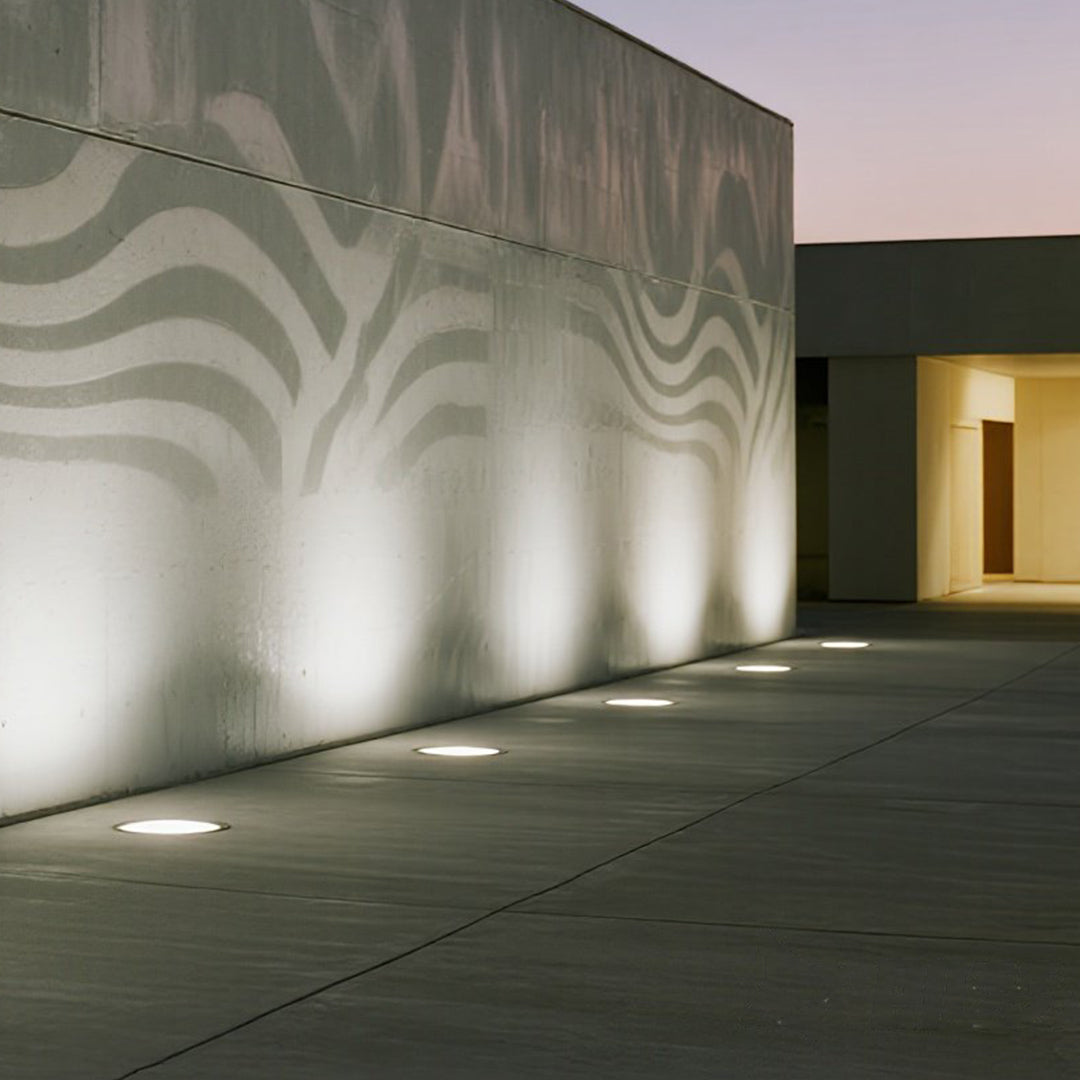 Compact round in-ground fixture with LED array and weather-resistant design for pathway illumination