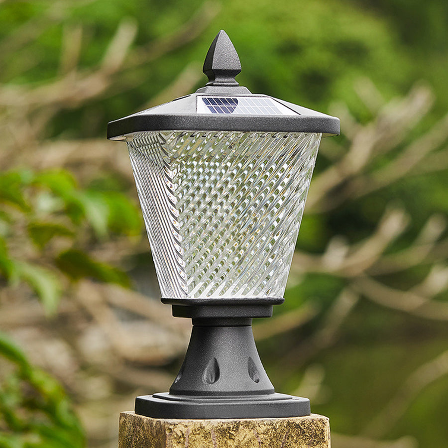 Decorative solar post cap light with textured glass shade and ornamental finial top