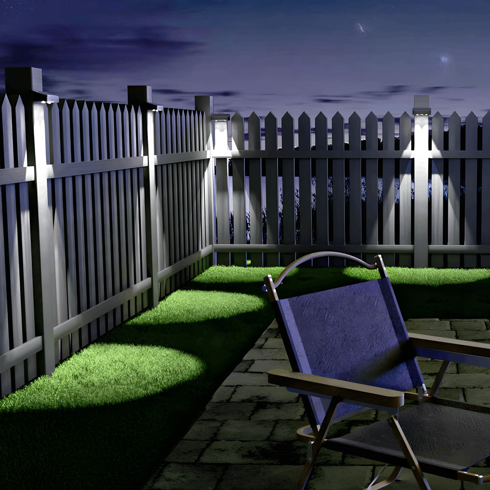 Modern backyard patio featuring LED spotlights mounted on dark wooden fence creating ambient lighting