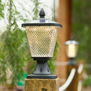 Traditional post cap lights installed along garden pathway providing consistent illumination spacing