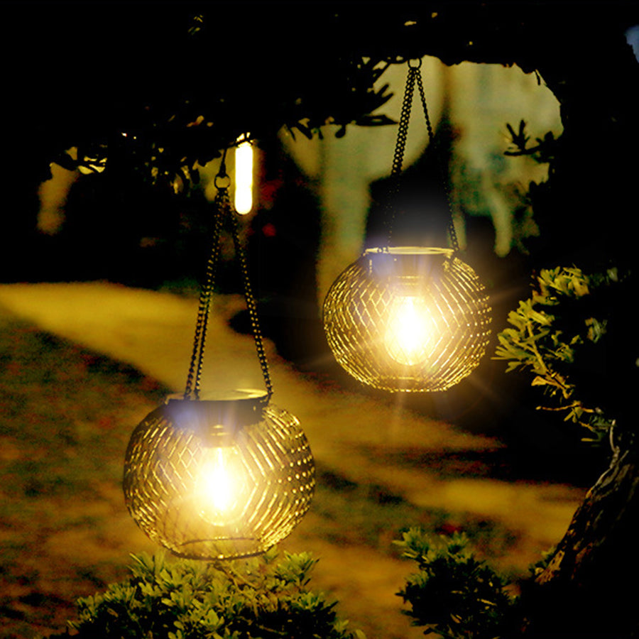 Rustic hanging lanterns providing soft illumination for outdoor dining and entertainment space