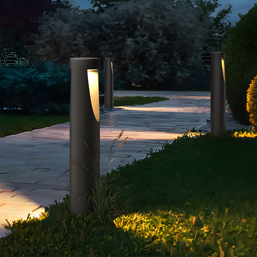 Evening pathway scene showcasing illuminated bollard lights along landscaped garden walkway